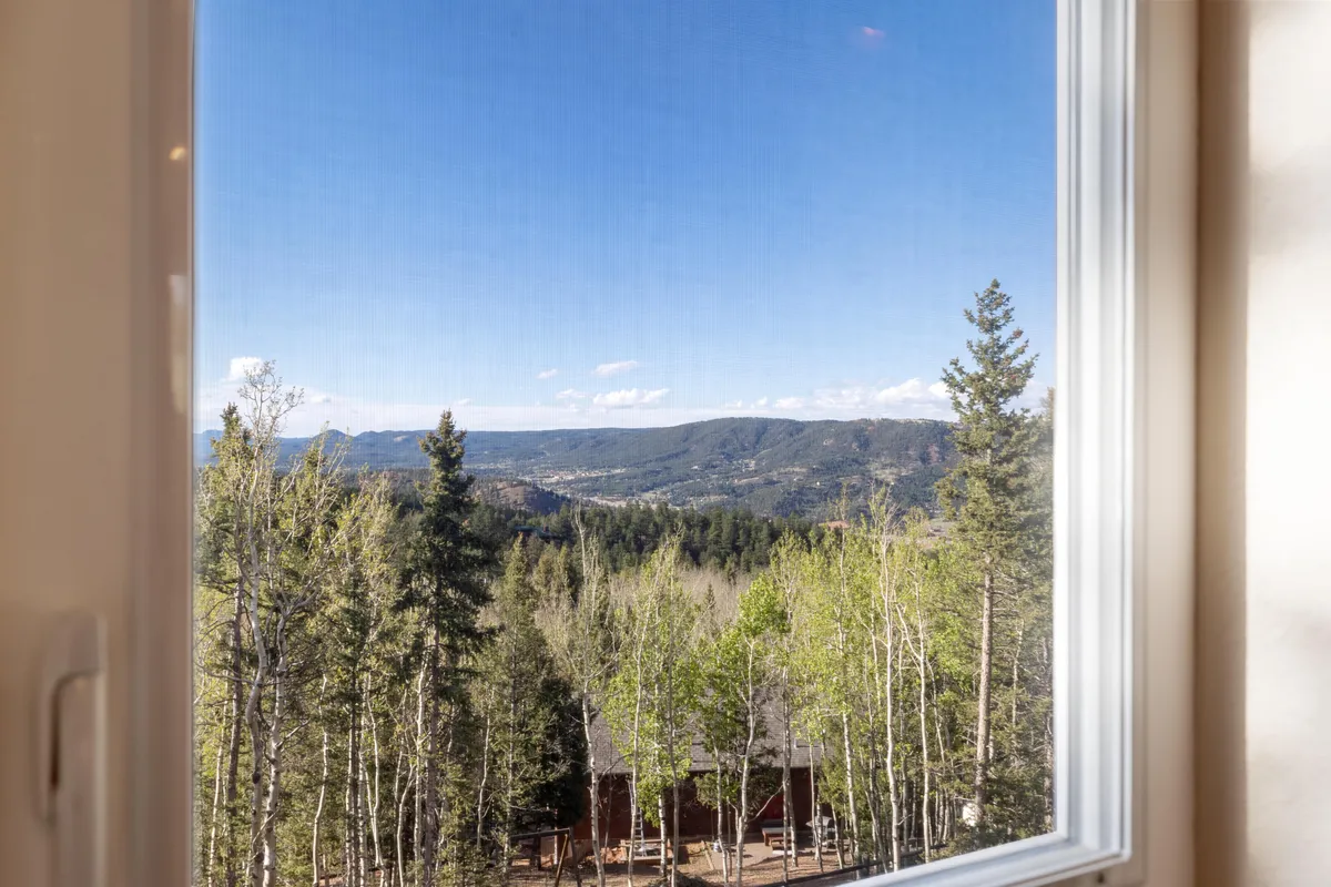 A serene landscape featuring a clear mountain view, dense trees, and a bright sky. The setting feels secluded yet accessible, perfect for hiking, nature walks, bird watching, or even wildlife sightings—activities highlighted in the section.